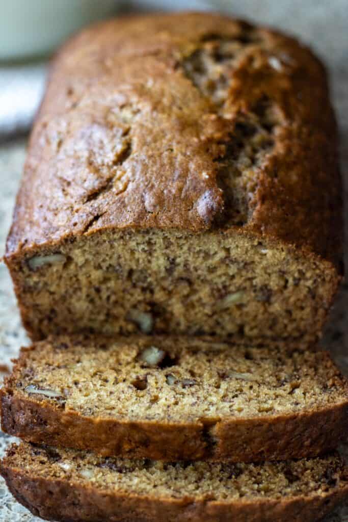 A loaf of sliced sourdough banana nut bread on a countertop.