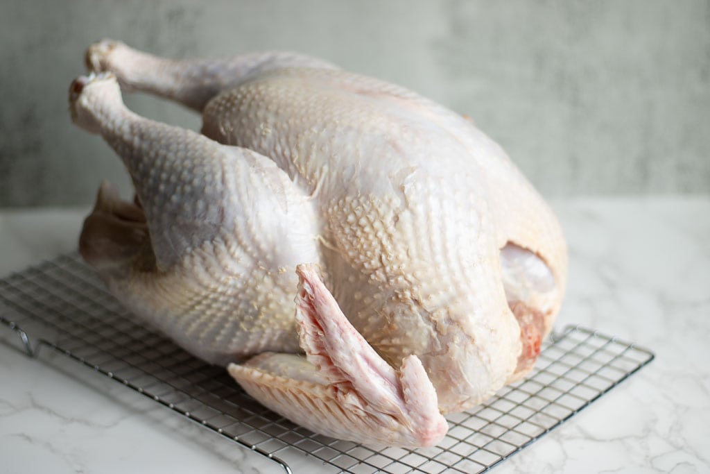 raw whole pasture raised turkey on rack