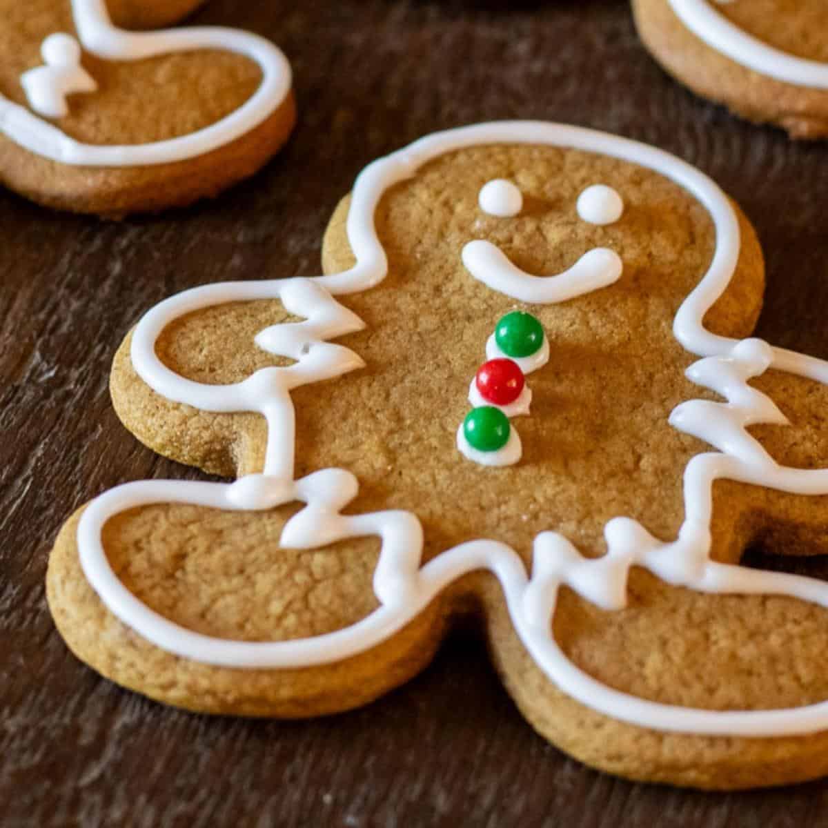 A sourdough gingerbread cookies decorated with icing and buttons.