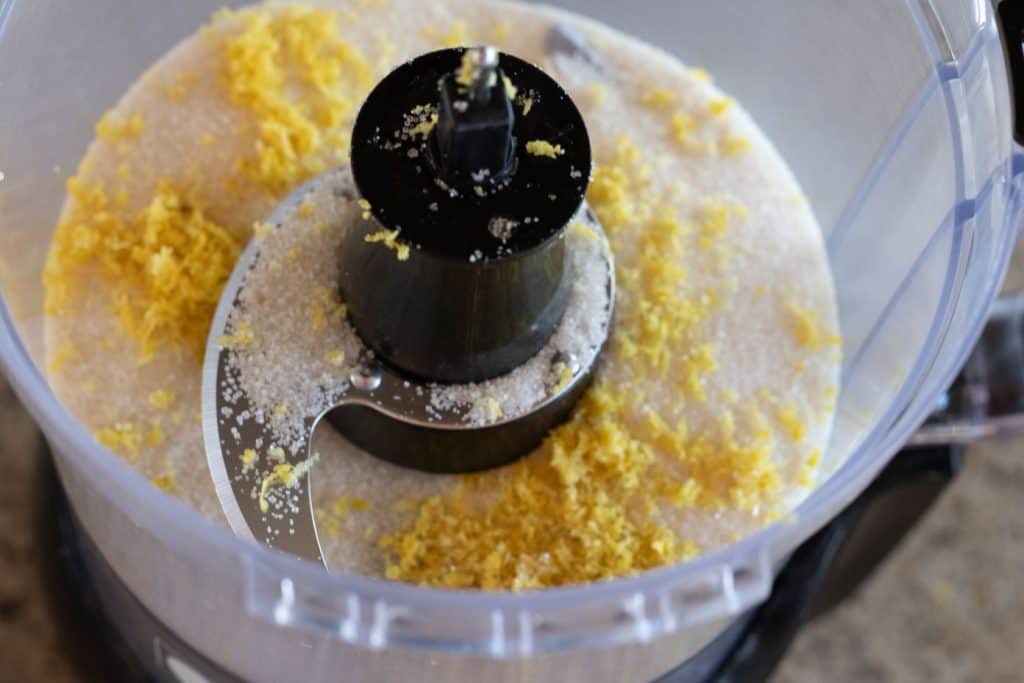 Sugar and lemon zest in a food processor.