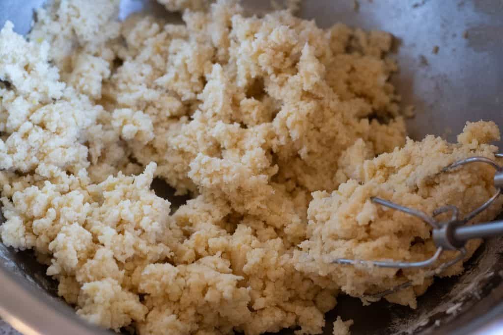 A rough shaggy dough for lemon shortbread cookies.