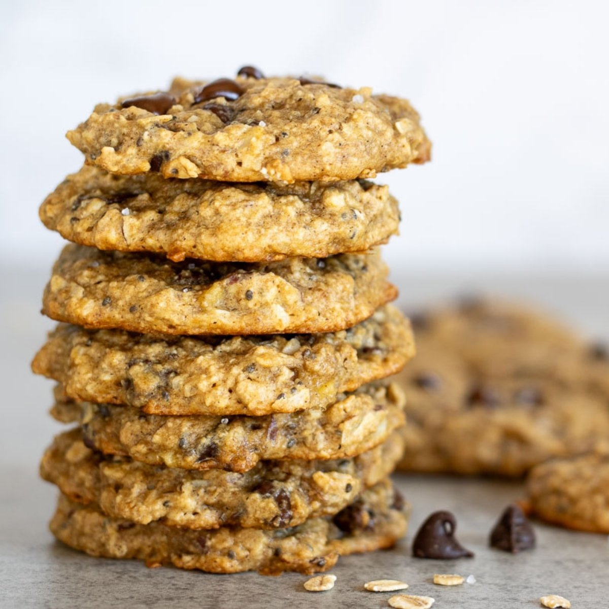 A stack of sourdough breakfast cookies with some chocolate chips and rolled oats.