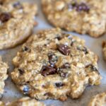 A close up view of a sourdough breakfast cookie with chocolate chips and a sprinkle of flaky salt.