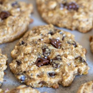 A close up view of a sourdough breakfast cookie with chocolate chips and a sprinkle of flaky salt.