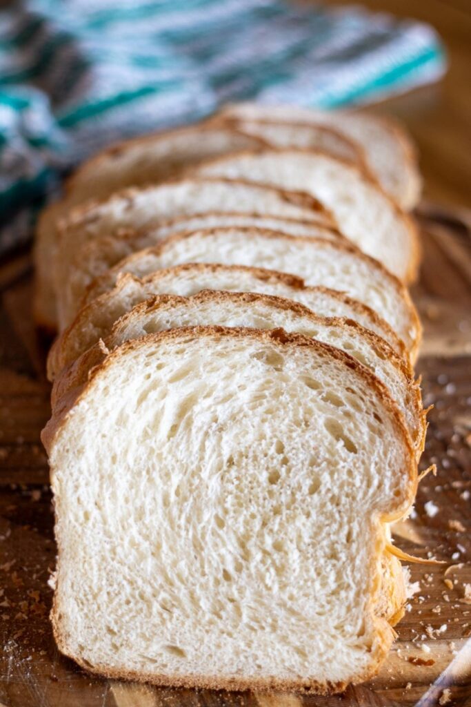 Homemade sandwich bread sliced on a cutting board.