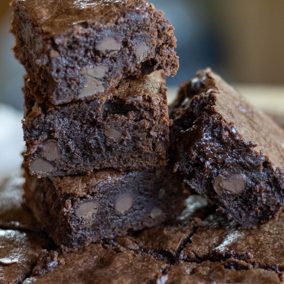 A stack of sourdough discard brownies studded with chocolate chips.